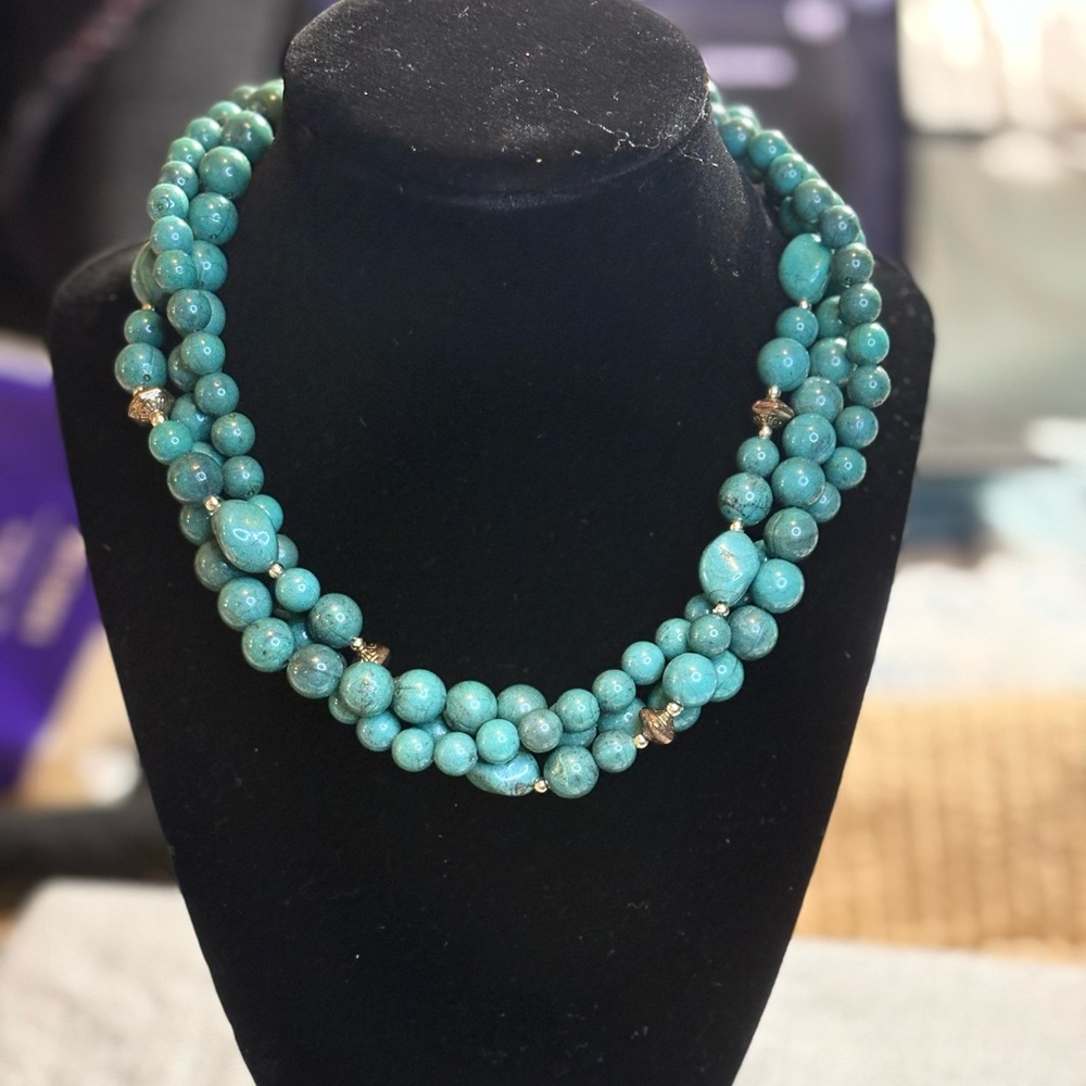 Vintage necklace with acrylic and gold tone beads and a shell pendant.